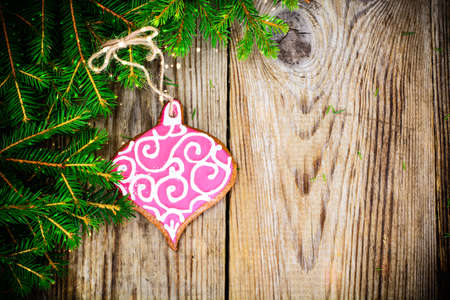 Abstract Christmas and New Year Background with Old Vintage Wooden Boards, Fir Branches, Gingerbread and Glossy Lights Studio Photoの写真素材