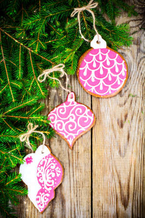Abstract Christmas and New Year Background with Old Vintage Wooden Boards, Fir Branches, Gingerbread and Glossy Lights Studio Photoの写真素材