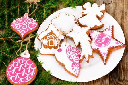 Abstract Christmas and New Year Background with Old Vintage Wooden Boards, Fir Branches, Gingerbread and Glossy Lights Studio Photoの写真素材