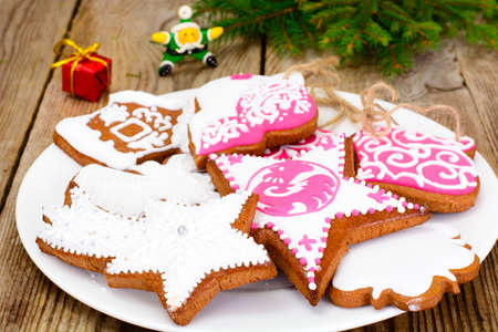 Abstract Christmas and New Year Background with Old Vintage Wooden Boards, Fir Branches, Gingerbread and Glossy Lights Studio Photoの写真素材