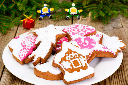 Abstract Christmas and New Year Background with Old Vintage Wooden Boards, Fir Branches, Gingerbread and Glossy Lights Studio Photoの写真素材