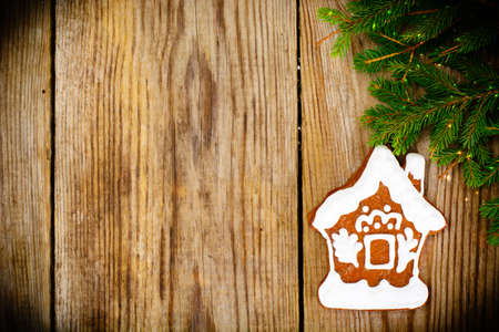 Abstract Christmas and New Year Background with Old Vintage Wooden Boards, Fir Branches, Gingerbread and Glossy Lights Studio Photoの写真素材
