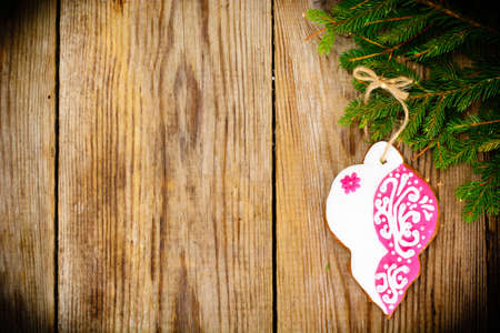 Abstract Christmas and New Year Background with Old Vintage Wooden Boards, Fir Branches, Gingerbread and Glossy Lights Studio Photoの写真素材