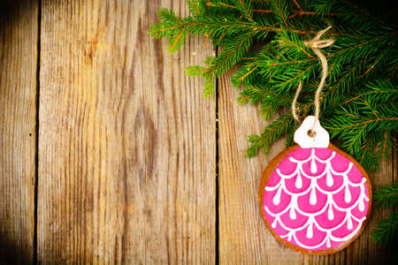 Abstract Christmas and New Year Background with Old Vintage Wooden Boards, Fir Branches, Gingerbread and Glossy Lights Studio Photoの写真素材