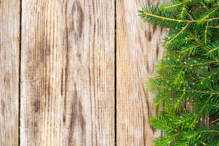 Abstract Christmas and New Year Background with Old Vintage Wooden Boards, Fir Branches and Glossy Lights Studio Photoの写真素材