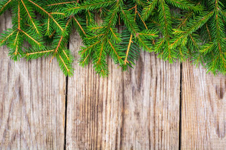 Abstract Christmas and New Year Background with Old Vintage Wooden Boards, Fir Branches and Glossy Lights Studio Photoの写真素材