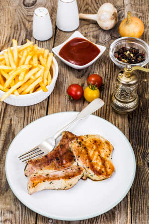Loin Roast with Potatoes Fries on White Plate Studio Photoの写真素材