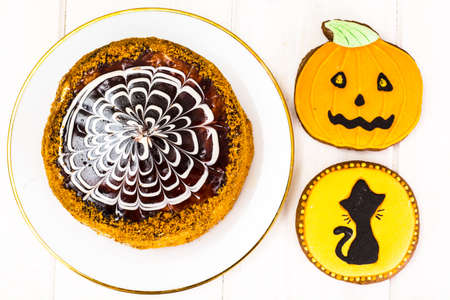 Esterhazy Almond Chocolate Cake on Wooden Background with Gingerbread for Halloween. Funny Holiday Food for Children Studio Photoの写真素材