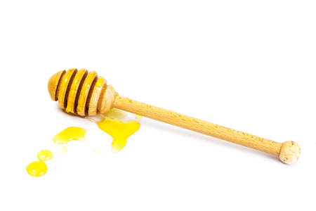 Honey dipper and fragrant honey into a bowl. Studio Photoの写真素材