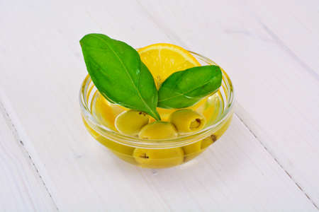 Green Olives with Oil and Basil Studio Photoの写真素材