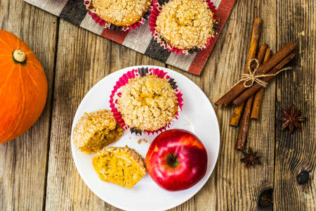 Flavored muffins with pumpkin and apple. Studio Photo