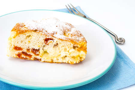 Apple pie with dried apricots on a white background. Studio Photo