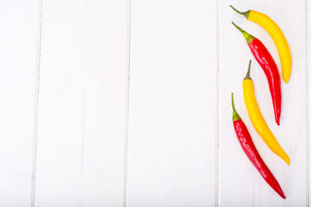 Chilli peppers on wooden background. Studio photo