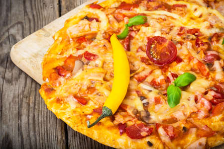Pizza with prosciutto, mushroom and tomatoes. Studio Photoの写真素材