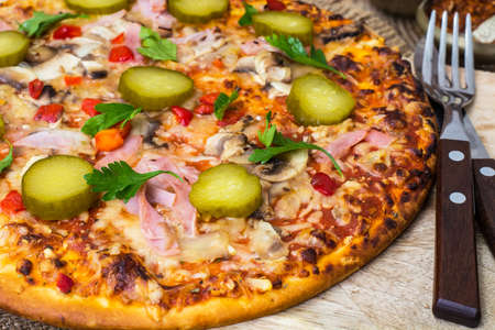 Homemade pizza with ham and mushroomsの写真素材