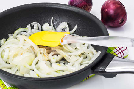 Browned onion in oil in a frying panの写真素材