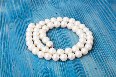 Pearl necklace on a blue background