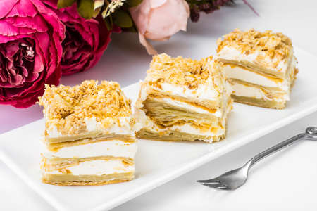 Portion cake of puff pastry with vanilla butter cream