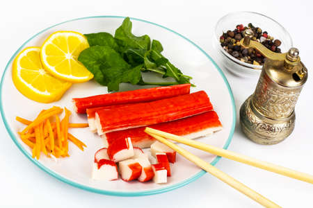 Crab sticks, lemon and arugulaの写真素材