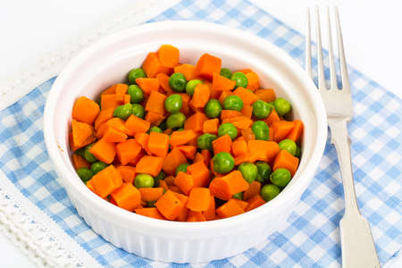 Carrots and green peas on a couple of Dietの写真素材