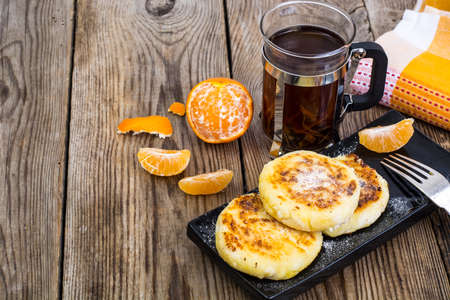 Hot sweet cheesecakes with tangerines and honeyの写真素材