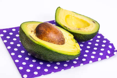 Sliced avocado with stone on blue backgroundの写真素材