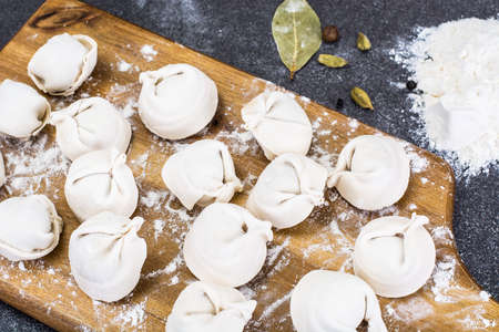 Cooked ravioli on the board with flourの写真素材