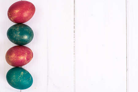 Easter, color painted eggs on white boardsの写真素材