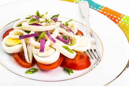Seafood salad with squid on white backgroundの写真素材