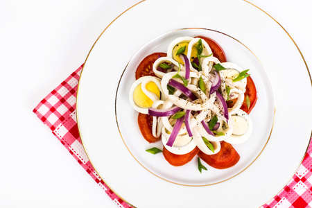 Seafood salad with squid on white backgroundの写真素材