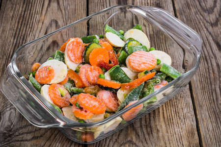 Mix of deep-frozen vegetables in glass formの写真素材