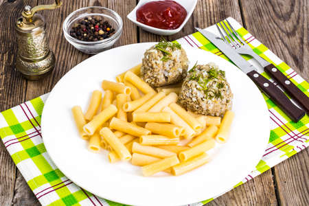 Pasta with meatballs and ketchup for lunch
