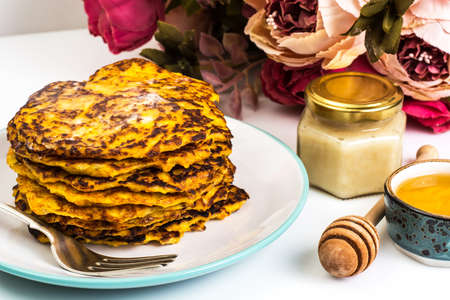 Carrot orange Pancake with honey on white background