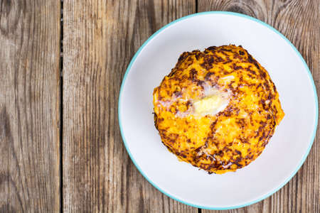 Pumpkin Pancake on plate on background of old wooden planksの写真素材