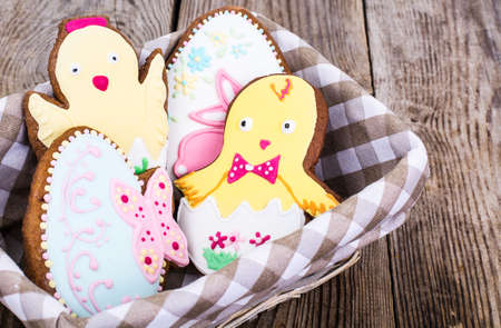 Gingerbread with Easter theme on a wooden backgroundの写真素材