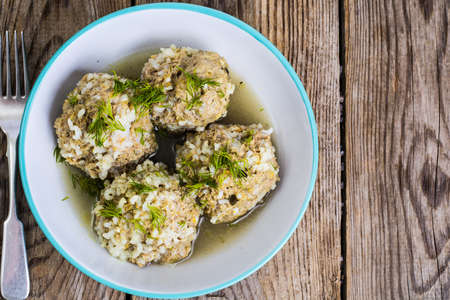 Meatballs meat with the rice grains in a blue ceramic bowlの写真素材