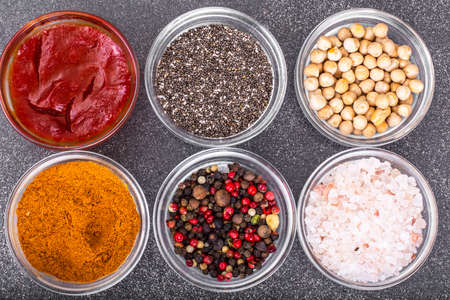 Various dry spices, sauces and cereals in glass molds on backgroの写真素材