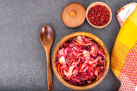 Salad of cabbage, carrots, beets and butter in a wooden bowl, reの写真素材