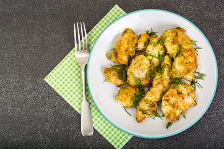 Pieces of fried chicken in breadcrumbs on plateの写真素材