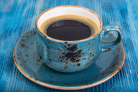 Crispy fresh croissant and hot espresso on blue backgroundの写真素材