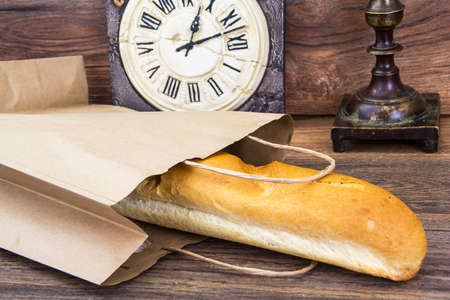Fresh warm baguette in paper bagの写真素材