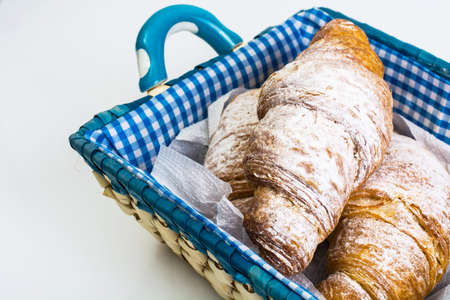 Delicious crispy croissants in bread basketの写真素材