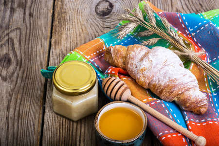 Croissants with powdered sugar on background of old boardsの写真素材