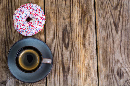 One donut with white frosting and colored sprinkles candyの写真素材