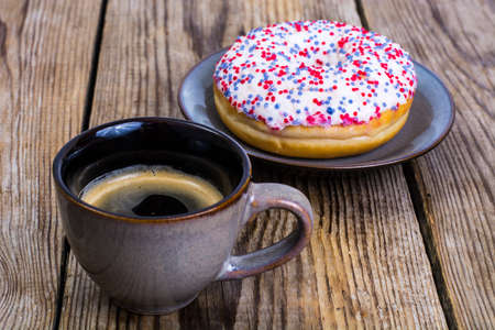 One donut with white frosting and colored sprinkles candyの写真素材