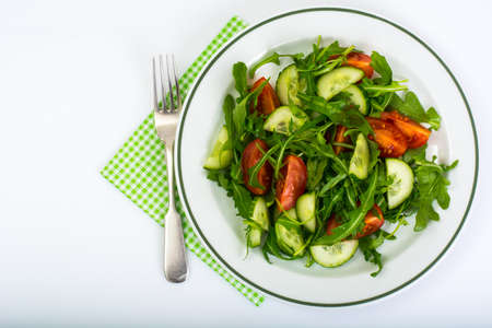 Healthy and diet food: arugula, cucumbers and tomatoes. Studio Photoの写真素材
