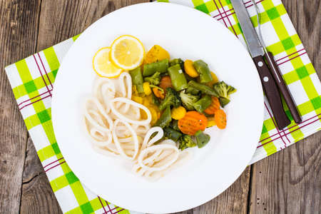Squid rings with vegetable garnishの写真素材