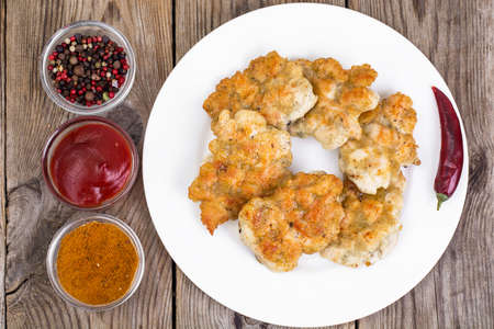 Fried chicken cutlets on white plateの写真素材