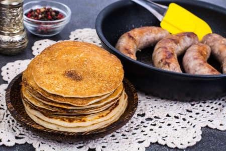 Hot pancakes with homemade sausage in frying pan. Studio Photoの写真素材