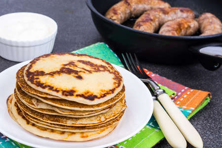 Hot pancakes with homemade sausage in frying pan. Studio Photoの写真素材